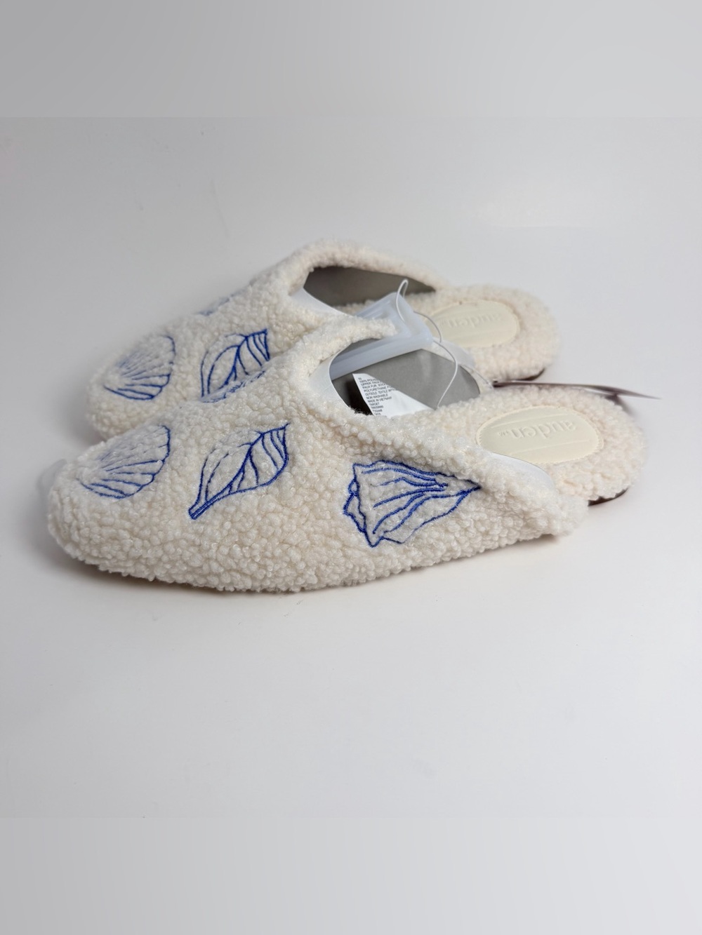 Auden Cream Sherpa Slip-On Slippers with Blue Leaf Stitching